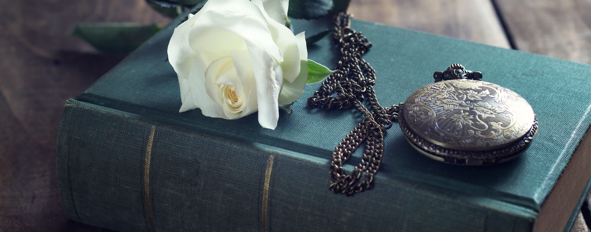 Vintage pocket watch on old books.