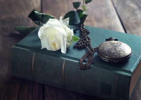 Vintage pocket watch on old books.