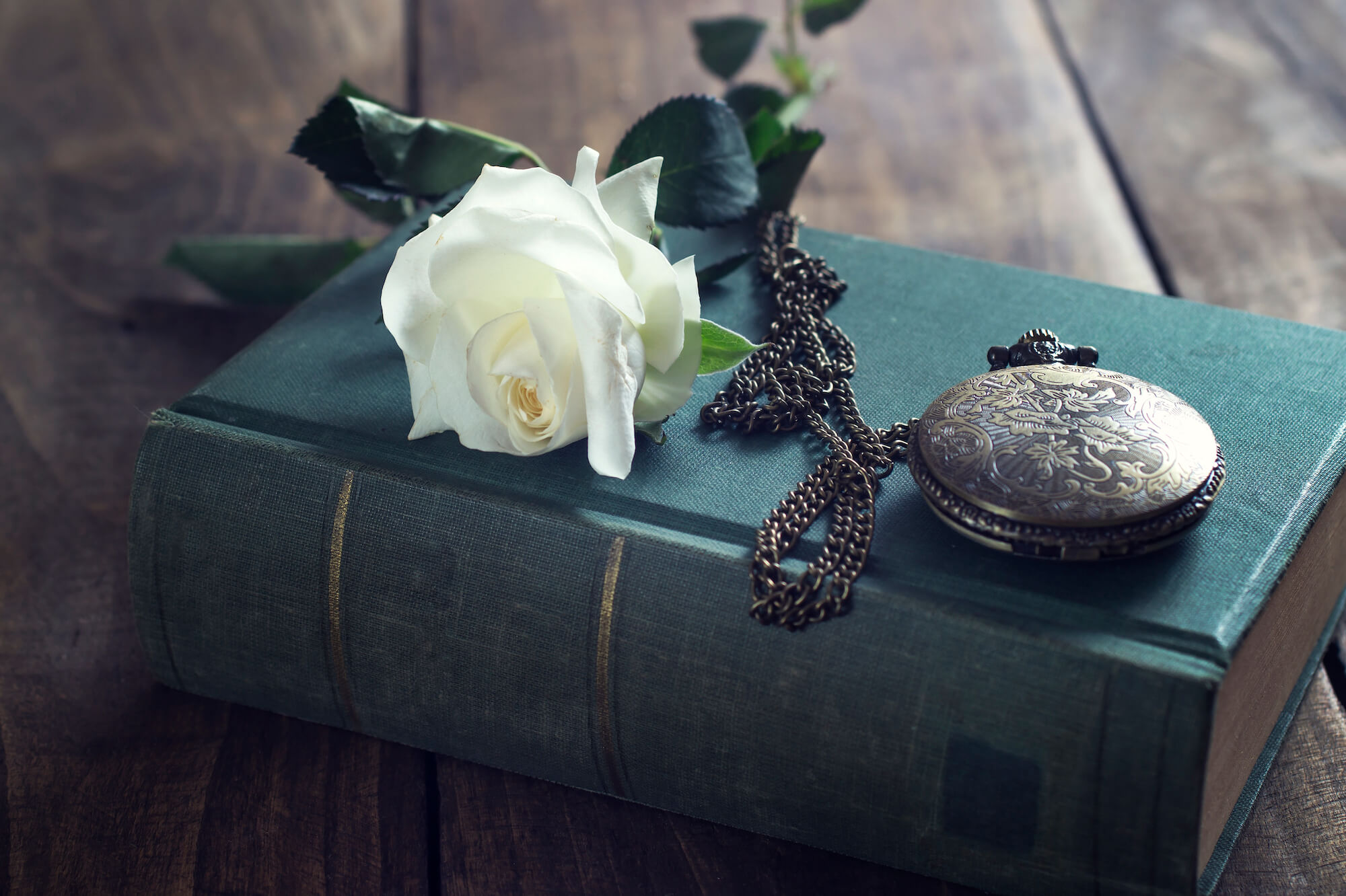 Vintage pocket watch on old books.