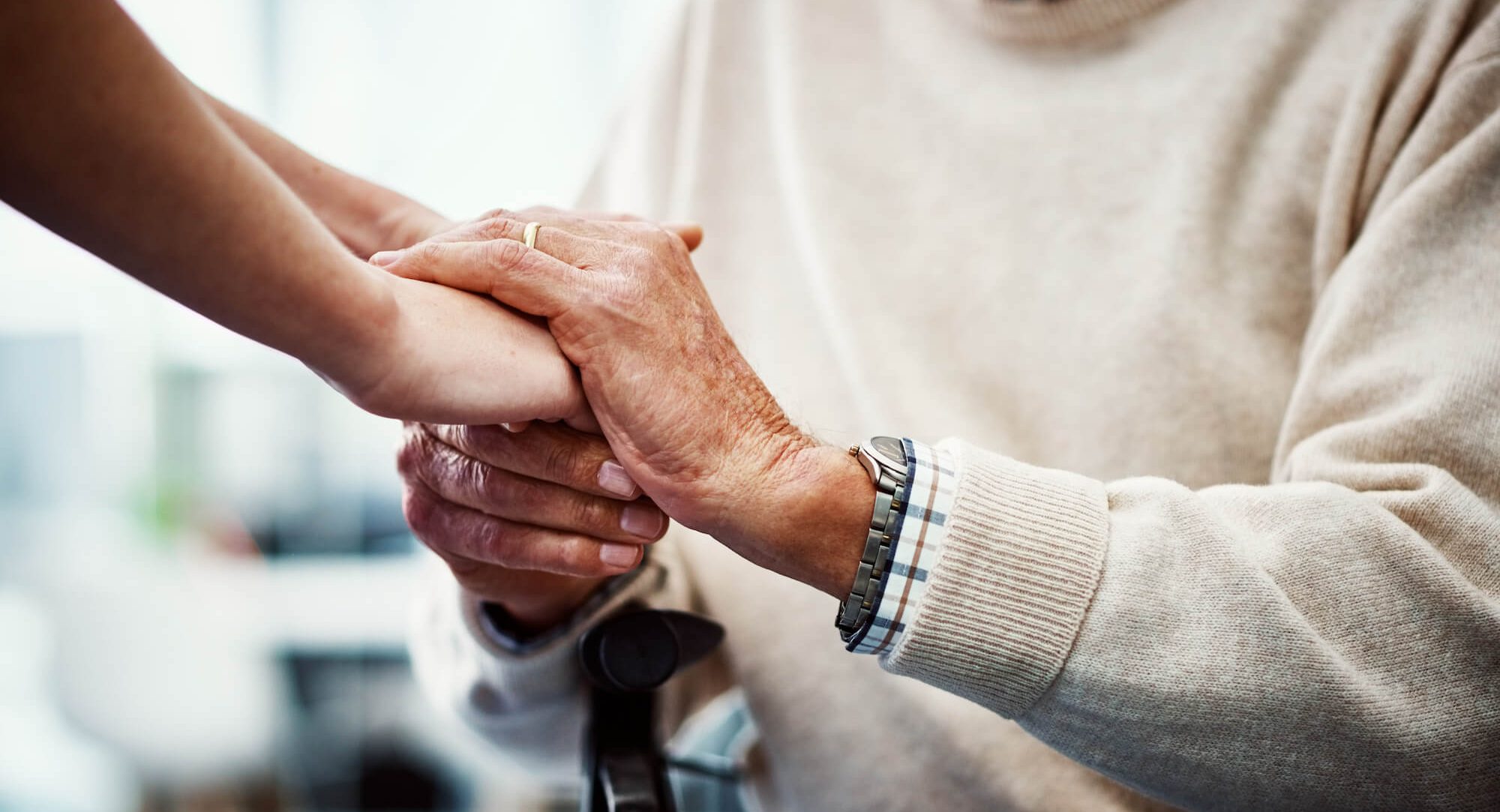Cropped shot of an unrecognizable female nurse holding her senior patient's hand in comfort